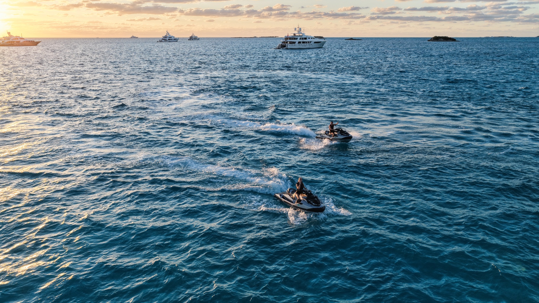 Two jet skis at sunset alongside Birdy